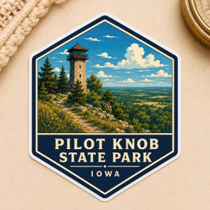 May include: A hexagonal sticker featuring a stone observation tower on a hill, surrounded by pine trees and wildflowers, overlooking a vast green landscape under a blue sky with white clouds. The text reads PILOT KNOB STATE PARK IOWA.