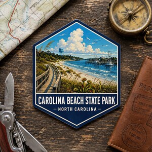 May include: A hexagonal sticker featuring a scenic illustration of Carolina Beach State Park, North Carolina. The image displays a wooden boardwalk, a sandy beach, a water tower, boats, and Venus flytraps under a blue sky with white clouds.