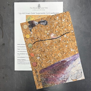 May include: A rectangular sample of Up Hill Down Dale cork wallpaper featuring a natural tan cork texture, a black line drawing of a bird, and a purple landscape section with a small sheep illustration. Five circular color swatches are aligned vertically.