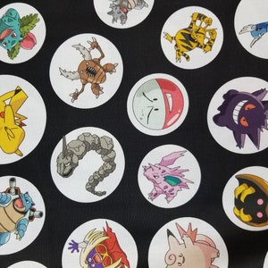May include: Black fabric with white circles featuring various Pokemon characters, including Pikachu, Snorlax, and Charizard.