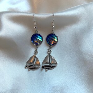 Cool handmade silver boat ocean inspired drop dangle earrings with blue holographic scale detail earrings