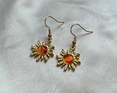 Cool gold plated sun earrings with orange centre on 18k gold plated hooks