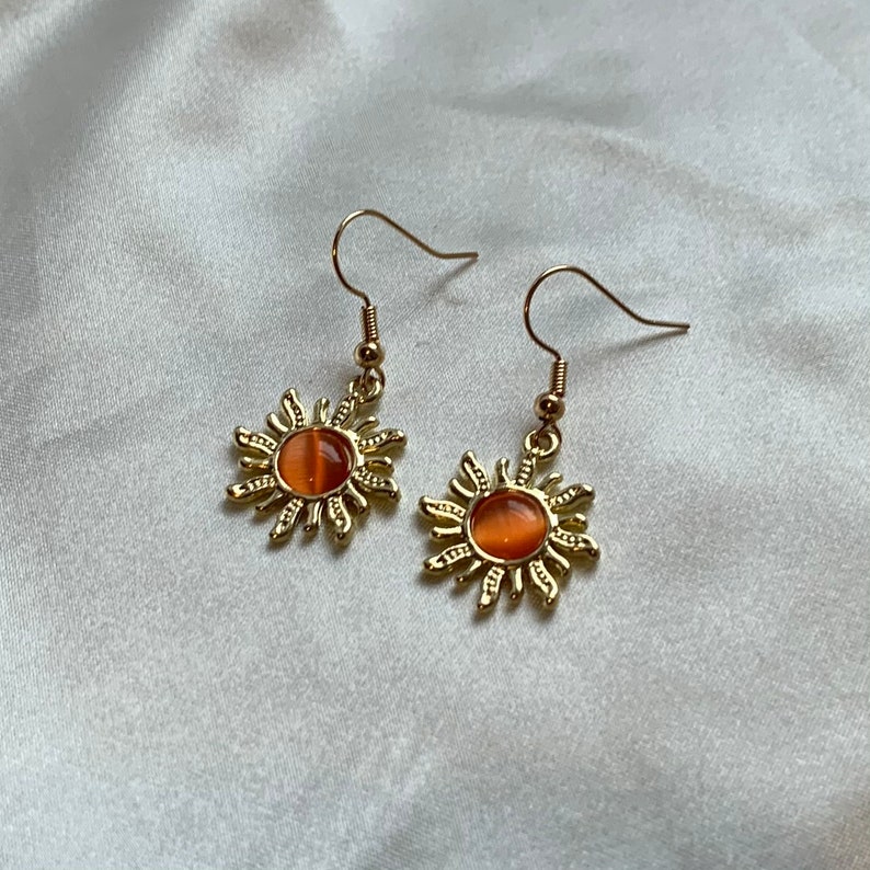 Cool gold plated sun earrings with orange centre on 18k gold plated hooks 