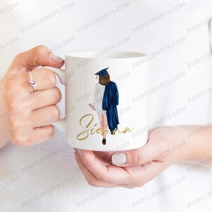 May include: White ceramic mug with a graduation cap and gown illustration. The text "Sienna" is written in gold script on the mug.