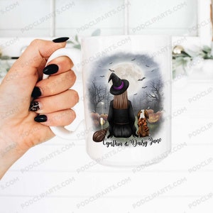 May include: White ceramic mug with a black and white illustration of a witch with a black cat and pumpkins. The text "Cynthia & Daisy Jane" is printed on the mug.