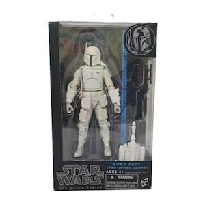 May include: A Star Wars The Black Series Boba Fett Prototype Armor action figure in its original packaging. The figure is all white with a helmet, chest plate, and utility belt. Included are a blaster and a jetpack. The box features the Star Wars logo.