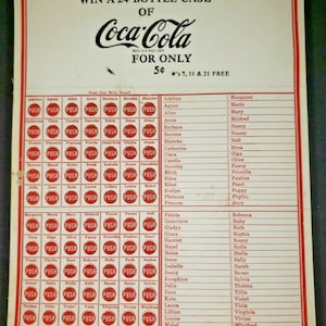 May include: A vintage Coca-Cola promotional game card with a red border. The card features a grid of names, each with a red "PUSH" button next to it. The text "WIN A 24 BOTTLE CASE OF Coca-Cola FOR ONLY 5¢ #'s 7, 11 & 21 FREE" is printed at the top of the card.