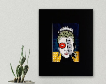 May include: A framed abstract painting of a person's face with a red eye and a black and white geometric pattern over the other eye. The background is a dark blue with yellow and white geometric shapes.