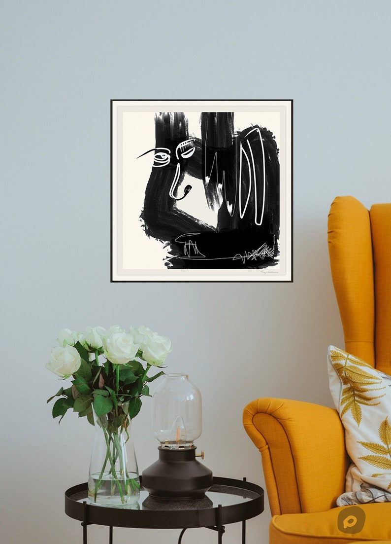 May include: Black and white abstract art print in a black frame. The print features a stylized face with bold lines and brushstrokes.