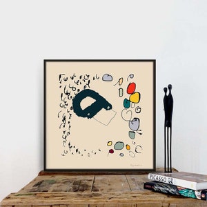 May include: A framed abstract art print with a black and teal shape, colorful circles, and black scribbles on a cream background. The print is titled "Clay Anderson".