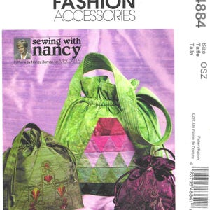 May include: McCall's Fashion Accessories sewing pattern featuring three drawstring bags in shades of green and purple. The pattern includes a large green bag with a pink and green geometric design, and two smaller bags with embroidered details.