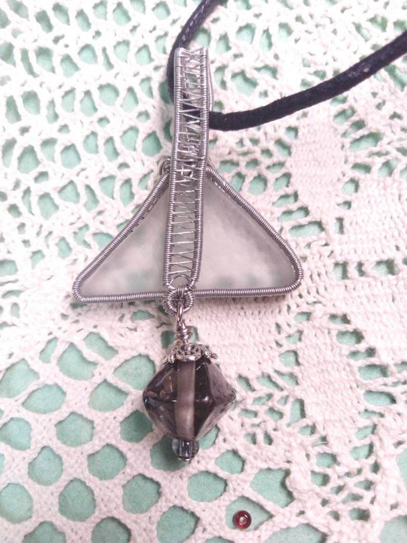 Unique triangular pendant with a pale sea glass wrapped in silver coated copper wire and a smokey glass bead dangling under.