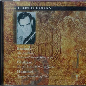 May include: CD case featuring Leonid Kogan, a black and white portrait of a man with a violin. The cover has a sepia-toned background with musical notes and text. Titles include Brahms, Giuliani, and Hummel.