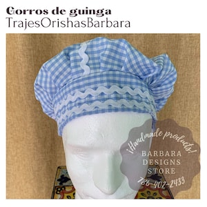 May include: A blue and white gingham fabric hat with a white scalloped trim. The hat is on a white mannequin head. The text "!handmade products! BARBARA DESIGNS STORE 786-402-2433" is visible in the image.