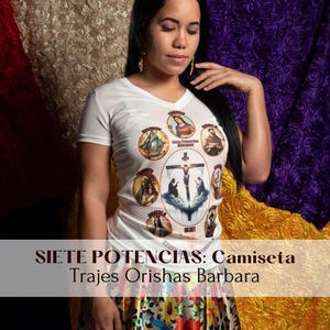 May include: White t-shirt with a colorful graphic print of seven religious figures and the text "Siete Potencias Africanas" and "Olofi". The text "SIETE POTENCIAS: Camiseta Trajes Orishas Barbara" is at the bottom of the image.