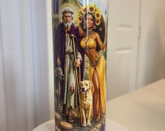 May include: A cylindrical tumbler featuring a full-wrap graphic print of an older man with a beard and a crown of thorns, and a woman wearing a sunflower crown. They stand on a stone path with two dogs, one dark and one golden, and wooden drums.