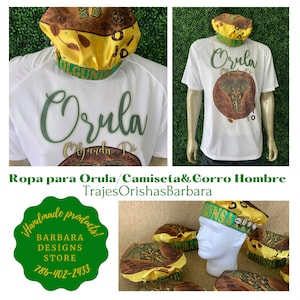 May include: White t-shirt with green text that says "Orula" and a brown and green graphic of an elephant. A white cap with a brown and green design and yellow trim. The text "Ropa para Orula/Camiseta& Gorro Hombre" and "Trajes OrishasBarbara" are also visible.