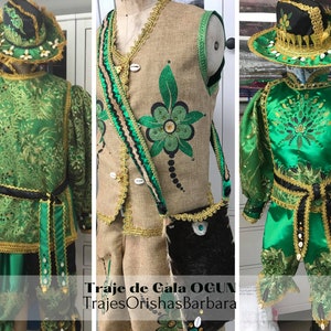 May include: A green and gold costume with a black belt and a green and gold hat. The costume is decorated with beads and sequins. The text "Traje de Gala OGUN" and "TrajesOrishasBarbara" is visible on the image.