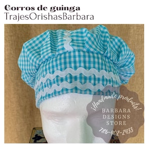 May include: A blue and white gingham fabric hat with a white lace trim. The hat is on a white mannequin head. The text "!handmade products! BARBARA DESIGNS STORE 786-402-2433" is on a white circle.