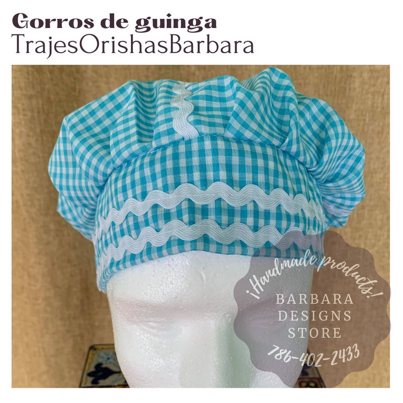 May include: A blue and white gingham fabric hat with a white lace trim. The hat is on a white mannequin head. The text "!handmade products! BARBARA DESIGNS STORE 786-402-2433" is on a white circle.