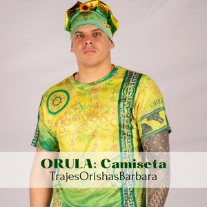 May include: A green and yellow t-shirt with a floral pattern and the text "ORULA" printed on it. The shirt is worn by a person wearing a green and yellow hat. The text "ORULA: Camiseta" and "TrajesOrishasBarbara" is printed below the person.