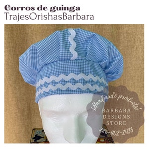 May include: A blue and white gingham chef's hat with white scalloped trim. The hat is on a white mannequin head. The text "!Handmade products! BARBARA DESIGNS STORE 786-402-2433" is visible in the image.