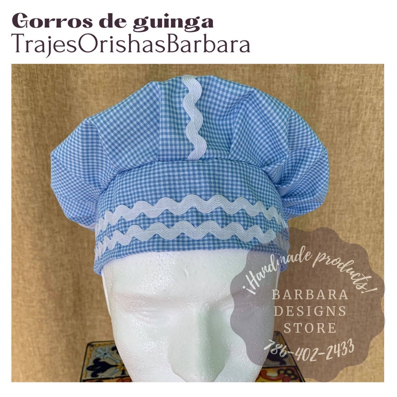 May include: A blue and white gingham chef's hat with white scalloped trim. The hat is on a white mannequin head. The text "!Handmade products! BARBARA DESIGNS STORE 786-402-2433" is visible in the image.
