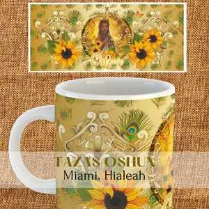 May include: White ceramic mug with a gold and green design featuring a woman with a crown, sunflowers, and peacock feathers. The text "TAZAS OSHUX Miami. Hialeah" is printed on the mug.