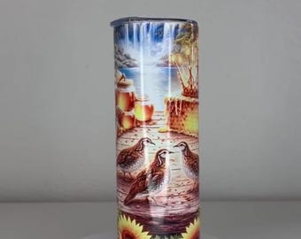 May include: A cylindrical tumbler featuring a colorful wrap-around print of three brown birds standing on a wooden dock near a lake, honey jars, a honeycomb cake, and a waterfall, with bright yellow sunflowers decorating the bottom edge.