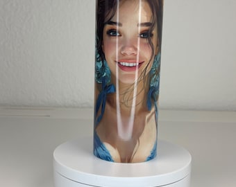 May include: A cylindrical tumbler featuring a full-wrap graphic print of a smiling person with brown hair and blue clothing. The tumbler is positioned on a white circular rotating display stand with a visible DC-5V port and a power switch.