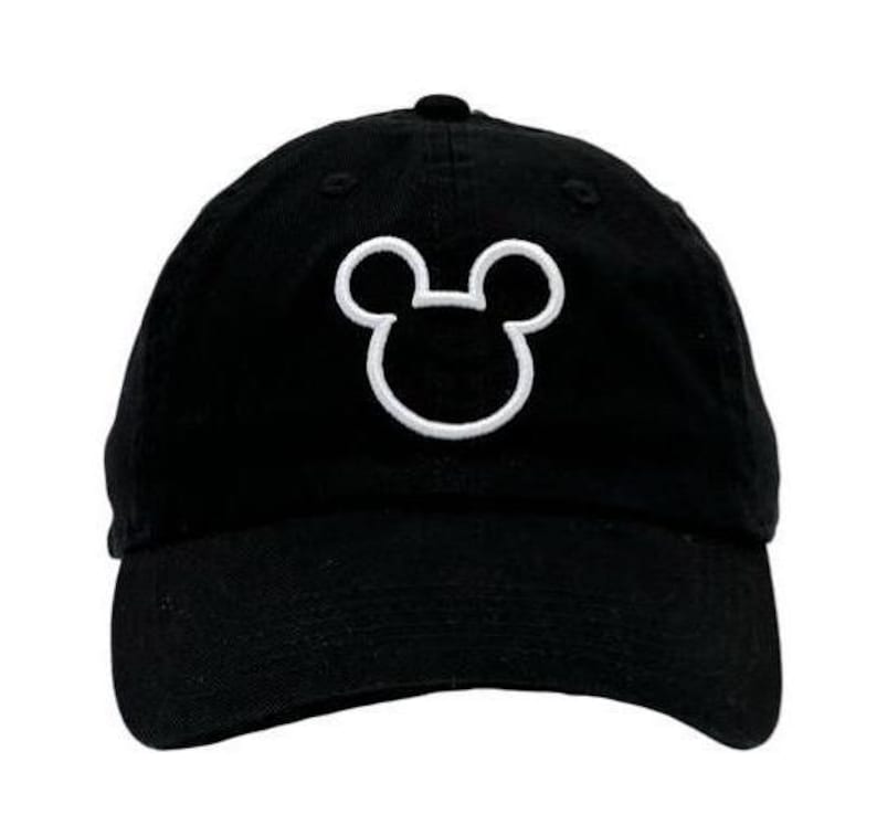 May include: A black baseball cap with a white embroidered Mickey Mouse silhouette.