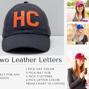 May include: A dark gray baseball cap with two large orange leather letters "HC" on the front. The cap is made of a soft, comfortable material and is perfect for any occasion.