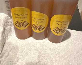 May include: Three amber glass bottles with black lids and yellow labels. The labels read "Herbal Extreme Hair Growth Oil".