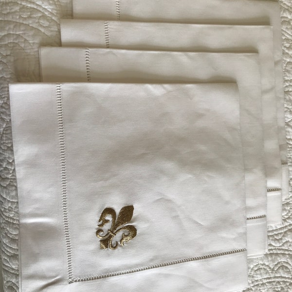 set of 4 white fabric dinner napkins with gold fleur-de-lis embroidery