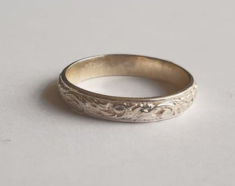silver ring with floral pattern