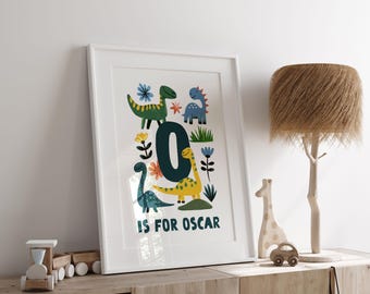 May include: A white framed print with a colorful illustration of the letter O surrounded by dinosaurs and flowers. The text "O is for Oscar" is at the bottom of the print.