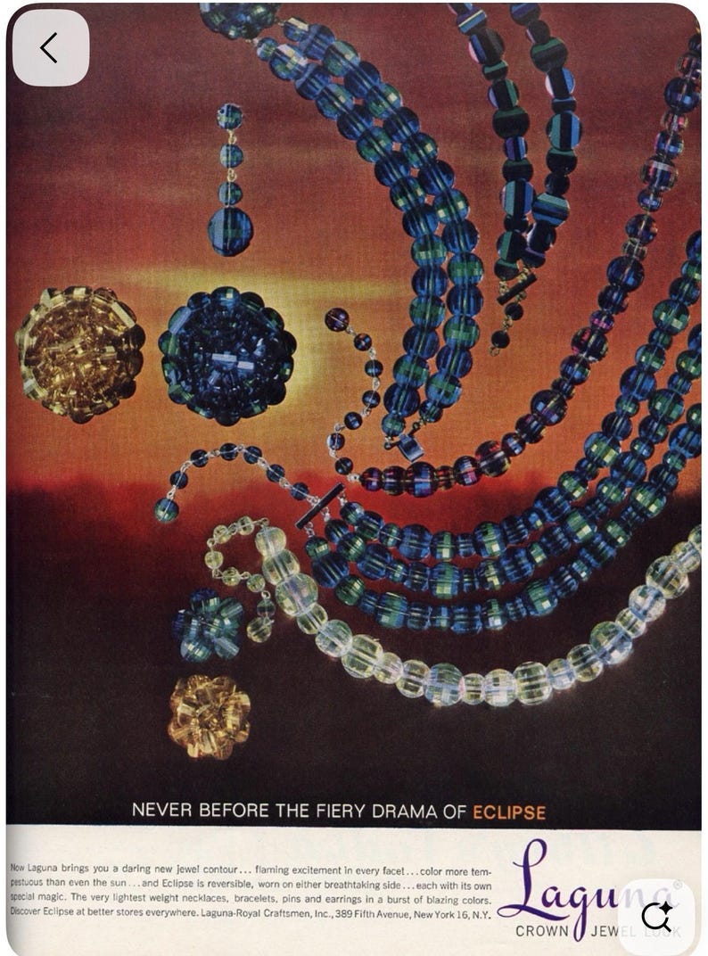 May include: An advertisement for Laguna Crown Jewel jewellery. The image features necklaces, earrings, and brooches in shades of blue, green, and gold. The text reads "NEVER BEFORE THE FIERY DRAMA OF ECLIPSE".