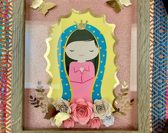 May include: A framed picture with a gold-trimmed image of the Virgin Mary, surrounded by paper flowers and butterflies. The frame is made of wood with a rustic finish.