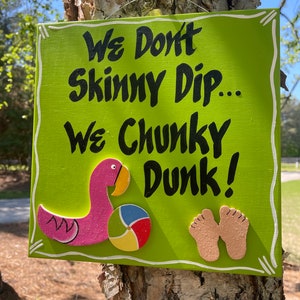 We Don’t Skinny Dip, We Chunky Dunk. Funny square wooden sign for the pool with separate flamingo, beach ball, bare feet wood attachments.