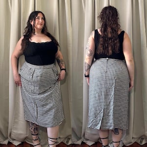 May include: A black and white gingham skirt with a high waist and a straight silhouette. The skirt is knee-length and has a subtle pleat detail at the front.