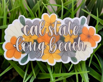 May include: A sticker with a floral design featuring yellow, orange, and grey flowers. The sticker says "cal state long beach" in a white cursive font.