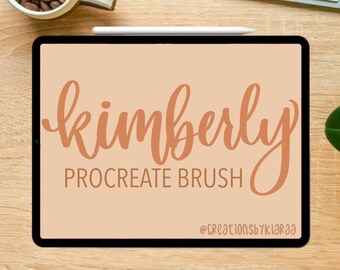 May include: A digital illustration of the word "kimberly" in a brown cursive font on a light brown background. The text "Procreate Brush" is below the word "kimberly" in a smaller font. The text "@creationsbykiaraa" is at the bottom of the image.
