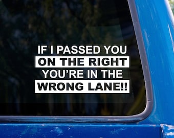 May include: A white sticker on a blue car window reads: "If I passed you on the right you're in the wrong lane!!"