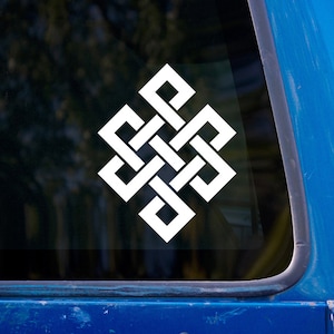 May include: White vinyl decal of the Endless Knot, a symbol of Buddhism. The intricate design is a continuous, interwoven pattern. The decal is displayed on a blue vehicle window, with a blurred background of trees.