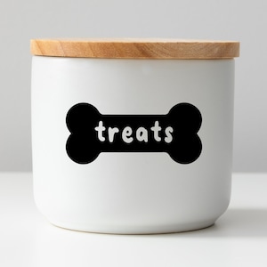 May include: White ceramic jar with a wooden lid and a black bone-shaped sticker that says "treats".