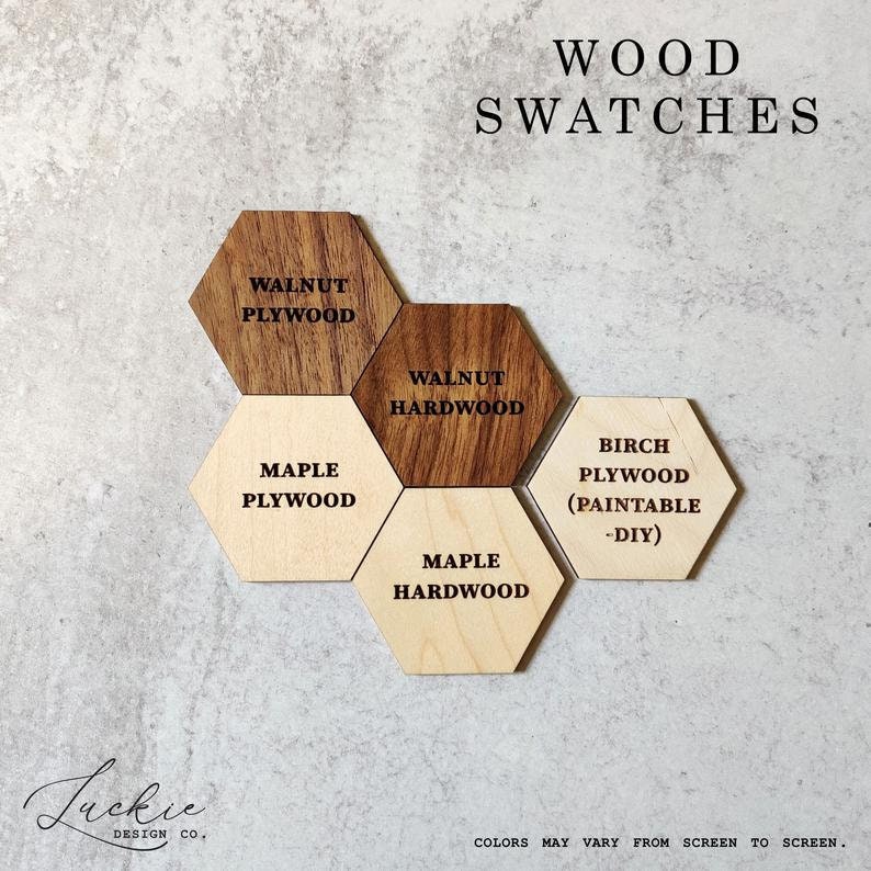 May include: Wood swatches in various shades of brown and natural wood. The swatches are in the shape of hexagons and labeled with the type of wood and whether it is plywood or hardwood. The text "WOOD SWATCHES" is at the top of the image.