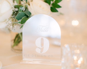 May include: Clear acrylic table number with the text "Table 9" and "Luckie Design Co."