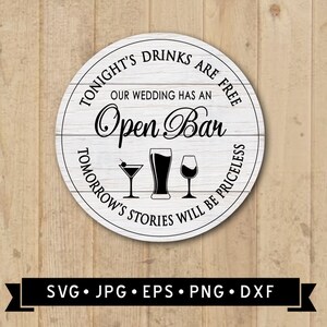 May include: A round wooden sign with the text "TONIGHT'S DRINKS ARE FREE OUR WEDDING HAS AN Open Bar TOMORROW'S STORIES WILL BE PRICELESS" in black lettering. The sign has a white background and a wood grain texture. There are three black silhouettes of drinks: a martini glass, a beer glass, and a wine glass.