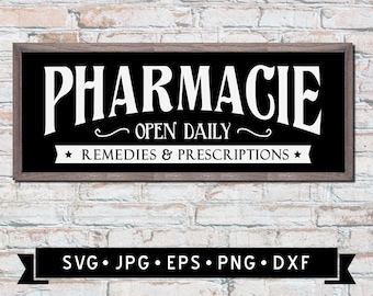 May include: A rectangular sign with a black background and white text that reads "PHARMACIE OPEN DAILY REMEDIES & PRESCRIPTIONS." The sign is framed in a dark wood and mounted on a white brick wall. A logo is in the lower left corner.