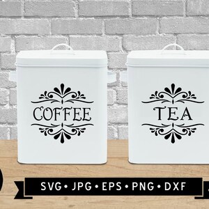 May include: Two white canisters with black lettering and decorative flourishes. The canisters are labelled "Coffee" and "Tea".